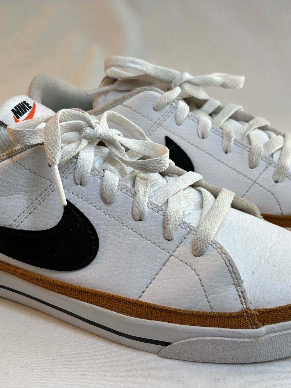 Nike White Sneakers with Black Swoosh and Brown Trim